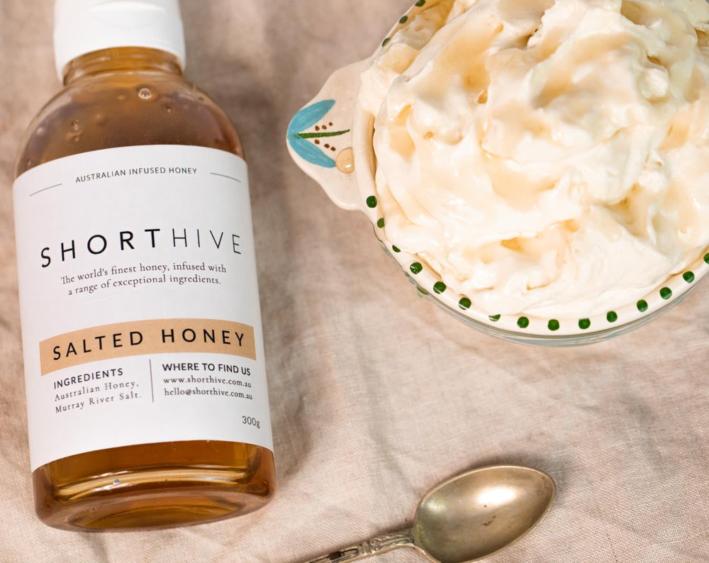 ShortHive Australian Caramel Salted Honey bottle pictured with a bowl of Salted Honey flavoured thickened whip cream as a recipe pairing idea.