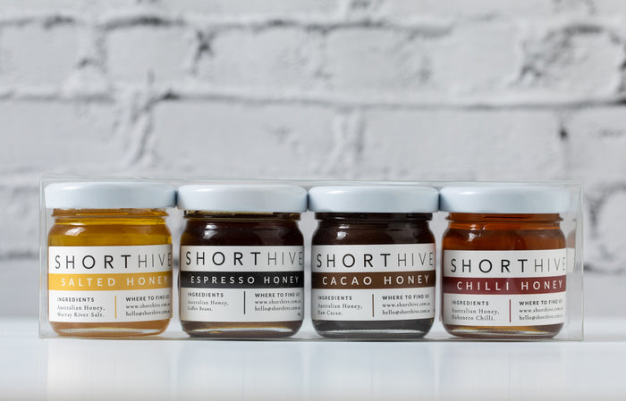 Mini 50g bottles of Salted (caramel) honey, Espresso (espresso) honey, Cacao (chocolate) honey on a white background. 